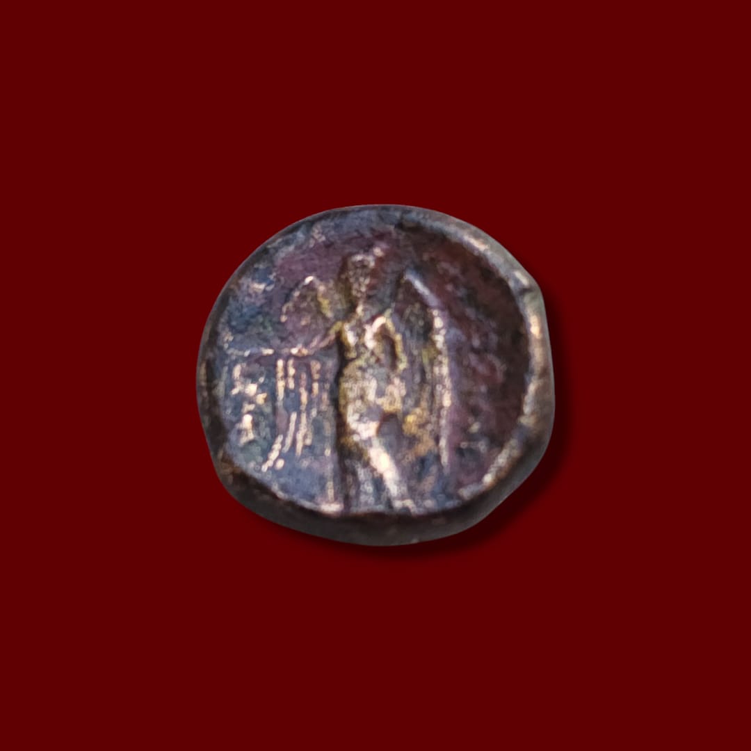 Ancient coin showing Nike standing beside an elephant, holding a wreath, on the reverse of a Seleukos I bronze.